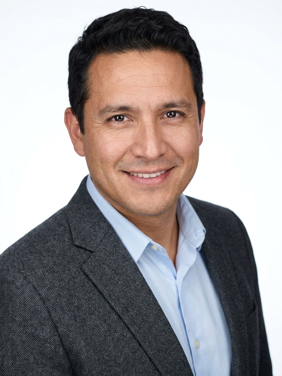 Example medical headshot: Studio White · Charcoal Blazer